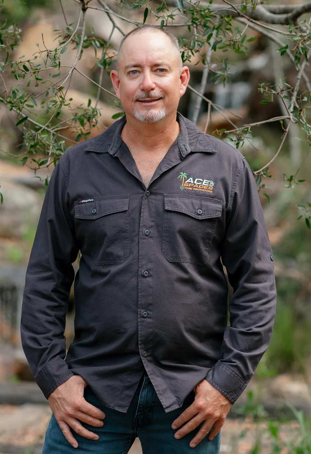 Russell Clark, founder of Ace of Spades, standing between two bottle trees